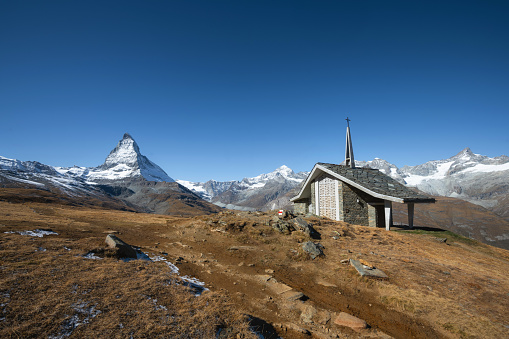 view up to little chapel on alp meadow in front of the Matterhorn mountain