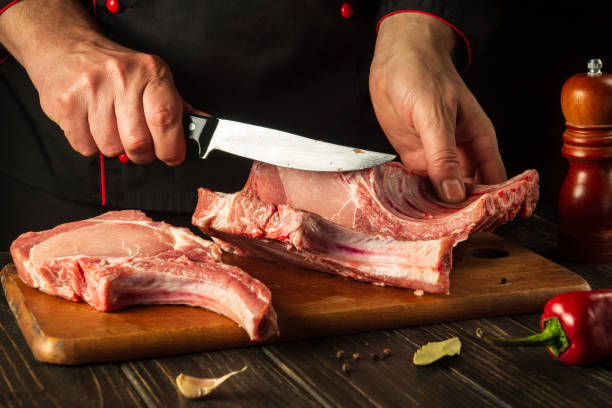 istock A professional chef cuts raw ribs on a cutting board before baking. Asian cuisine. Cooking delicious food in the kitchen 1427960314