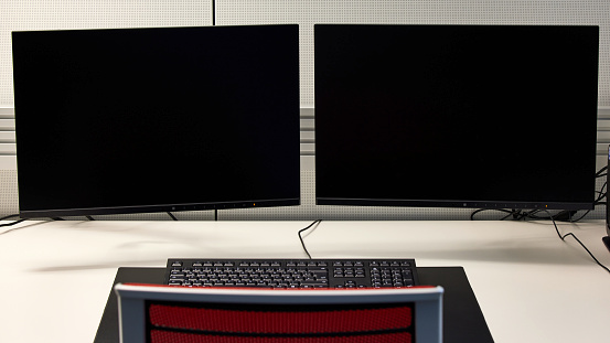 Keyboard and two black screens