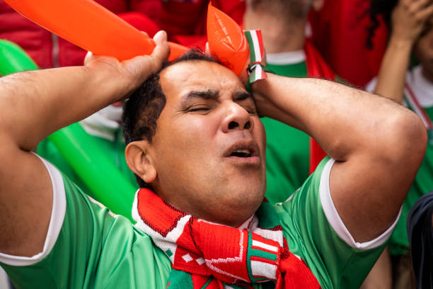 istock Soccer fan holding head in disappointment during match 1427961245