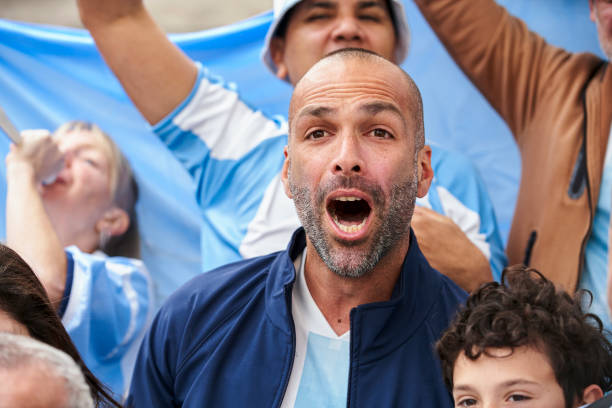 istock Football fan screaming while celebrating goal at stadium 1427961288