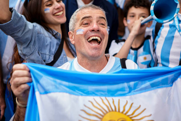 istock Argentinian football fan holding flag while cheering national team 1427961330