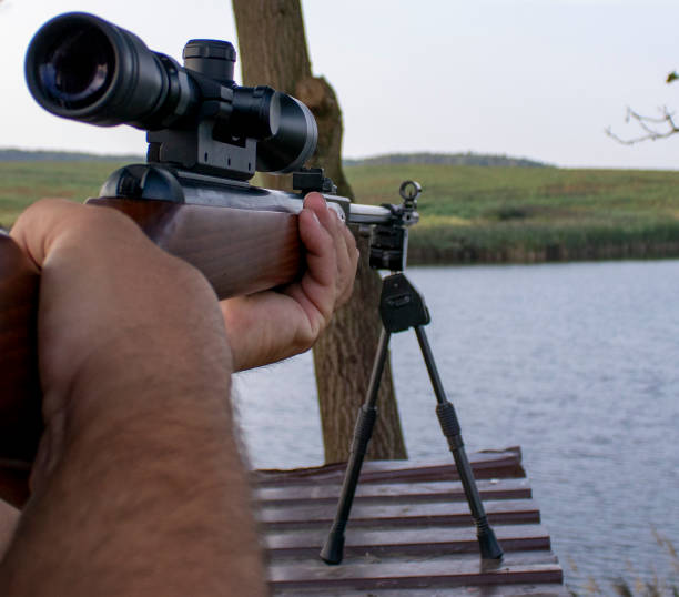 istock Hunter shooting with rifle. Point and shoot 1427961884