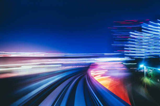 high speed train speeding over the monorail at night stock photo