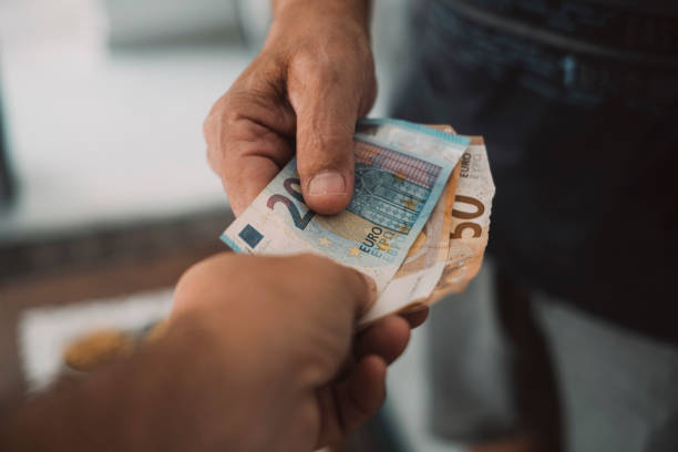 Close up of people exchanging cash banknote money. Concept of giving and taking euros. Economy and business. Present and loan back. Banking financial. Paying bills or credit action. One man give money stock photo