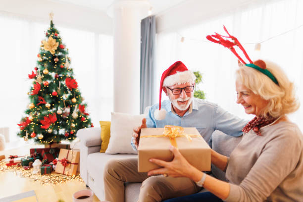 istock Senior couple exchanging Christmas presents 1427966340