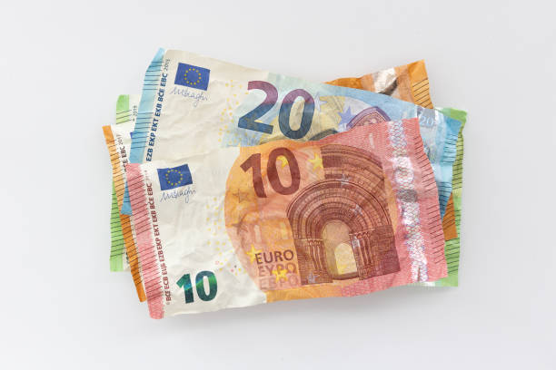 istock Stack of old crumpled European banknotes on white background 1427967789