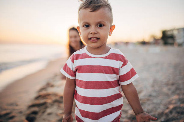istock A boy looking at the camera on the beach 1427967881