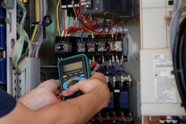 istock Electrical engineer work tester measuring voltage and current of power electric line cnc control cabinet 1427972578