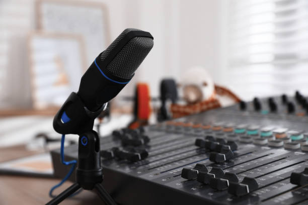 istock Microphone and professional mixing console in radio studio 1427972692
