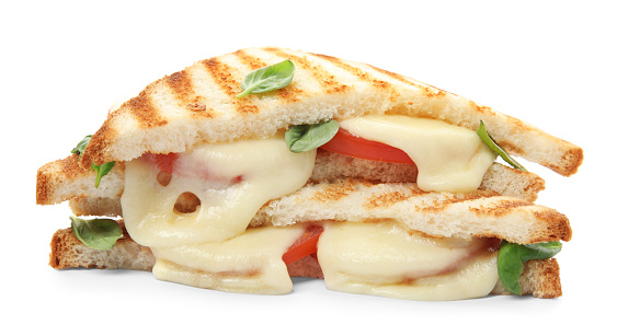 Delicious grilled sandwiches with mozzarella, tomatoes and basil isolated on white