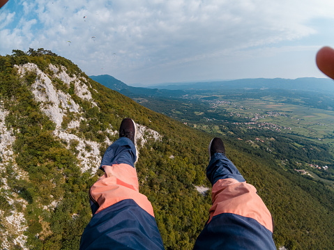 First person view of a skydiver enjoying views of a countryside below.