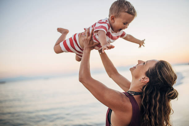 istock A mother playing with her son on the beach 1427974134