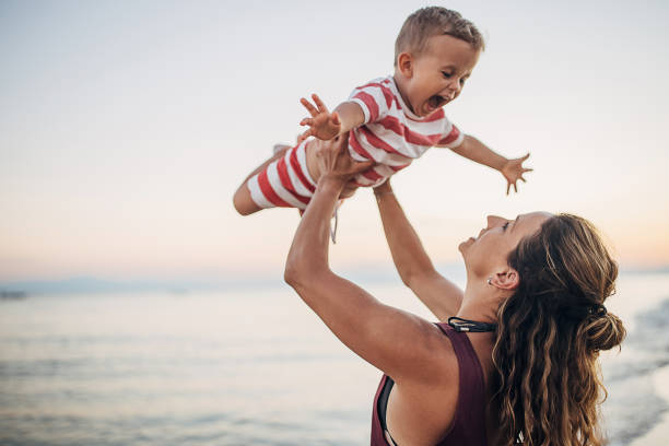istock A mother playing with her son on the beach 1427974176