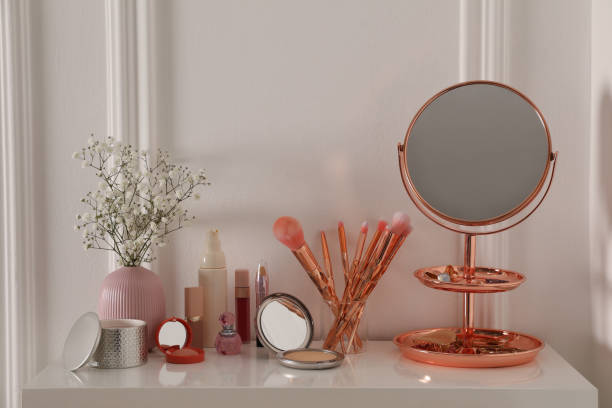 istock Mirror and makeup products on white dressing table near wall 1427974297