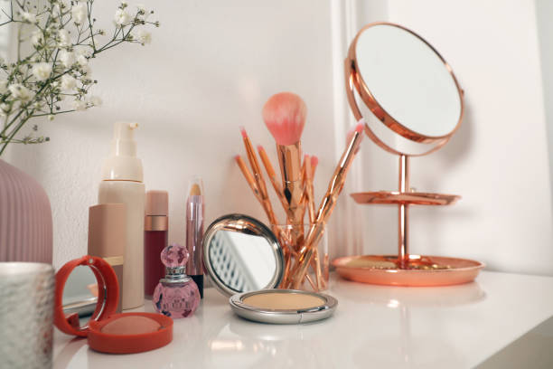 istock Mirror and makeup products on white dressing table near wall 1427974298