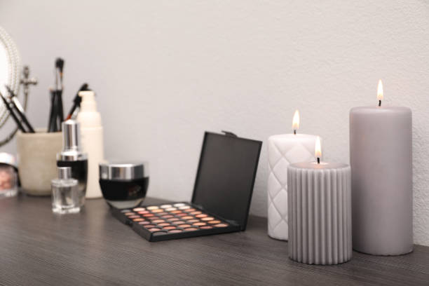 istock Mirror, candles and different makeup products on dark wooden dressing table near wall 1427974949
