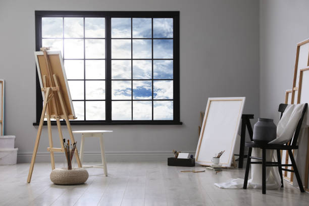 istock Stylish artist's studio interior with easel and brushes 1427976887