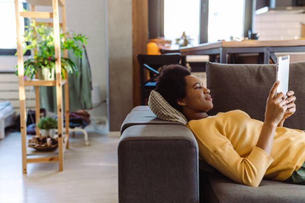 istock Side view of mature woman using digital tablet at home 1427977316