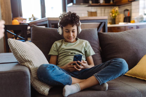 istock Multiracial cute boy consuming internet content on his smart phone 1427977340