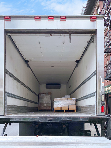 Empty moving truck with rear doors opened