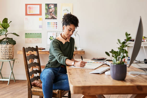 istock Schedule, calendar and planning business woman writing notes and working on a computer in a corporate office. Professional female planner serious about event management, project management task 1427978276
