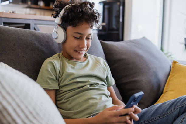 istock Multiracial cute boy consuming internet content on his smart phone 1427978999