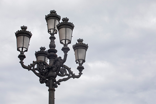 Iconic three headed lamps on O'Connell Bridge, over the River Liffey, during dusk in Dublin city centre.
