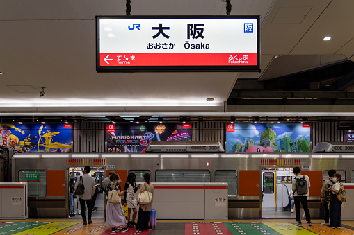 Osaka, Japan - August 14, 2022 : Passengers at JR Osaka Station in Osaka, Japan. It is a major railway station in the Umeda of Kita-ku, Osaka, Japan.