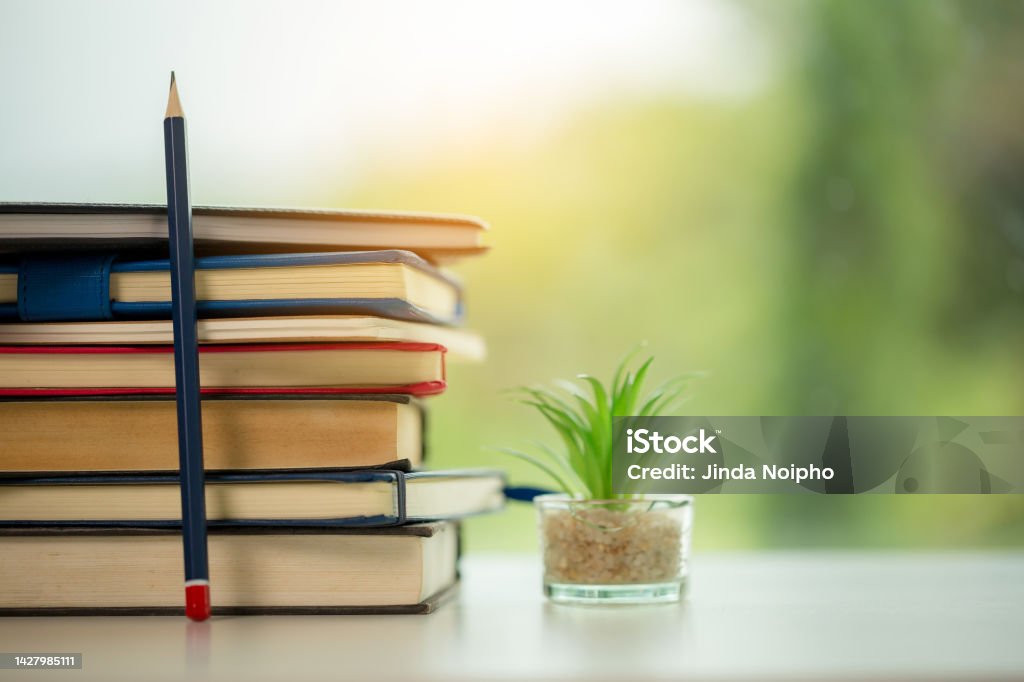 Object education green nature background with stack of ancient books or old bible, open paper book on wooden table with copy space. concept of back to school, research study Ancient Stock Photo