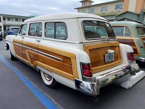 1952 Mercury Woody Station Wagon (Woodies on the beach) parked in front of a restaurant. California, United States. June 2022