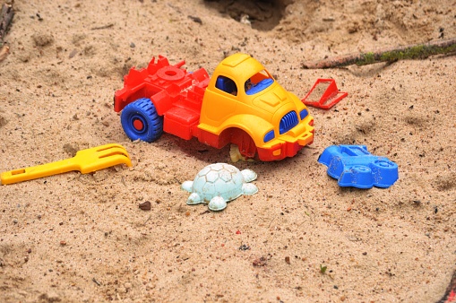 multicolored children's toys on the sand