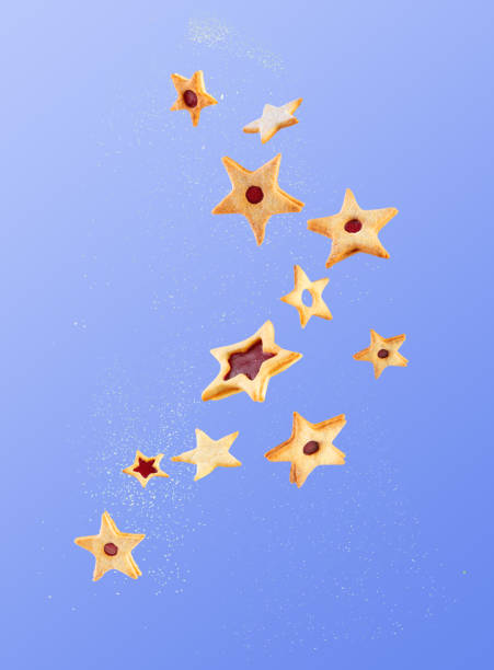 Star-shaped cookies are flying with powdered sugar