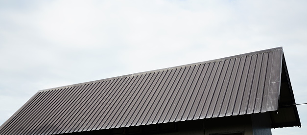 Brown color Metal sheet with  roof on sky background