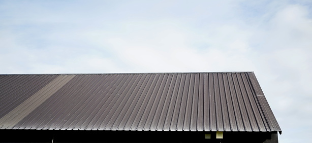 Brown color Metal sheet with  roof on sky background