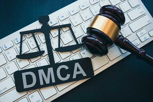 Plate with DMCA Digital Millennium Copyright Act sign, gavel and keyboard.