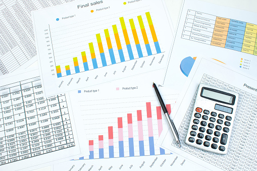 Financial printed paper charts, graphs and diagrams on the table