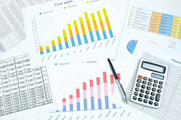 Photo of Financial printed paper charts, graphs and diagrams on the table. Top view