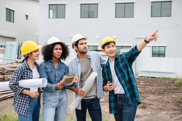 istock On the construction site, the engineer manager and the foremen conferred among themselves and pointed to different site projects in order to examine the various functions. 1428008792