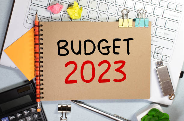 istock On a pink background, reports, black paper clips, glasses and a white notebook with the text BUDGET 2023 1428010709