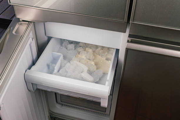 istock Ice cubes in the tray inside of automatic ice maker. 1428011664