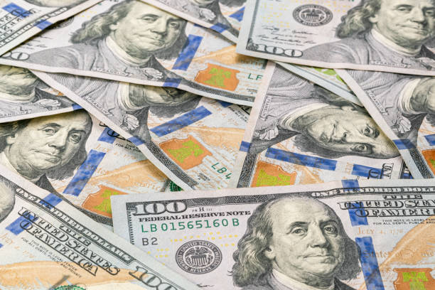 istock Closeup view pile of several one hundred U.S. dollars banknotes. 1428012476