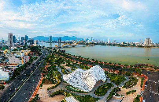 Drone view Da Nang city in with APEC public park abstracted curved dome and Dragon bridge by Han river - Da Nang city, Quang Nam Da Nang province, central Vietnam