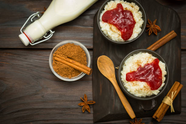 istock Rice pudding with cinnamon and strawberry jam on  the wooden background 1428014654