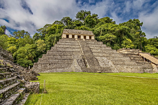 The Temple of the Inscriptions is the largest Mesoamerican stepped pyramid structure at Palenque ruins. Its importance lies on the hieroglyphic texts found, the sculptural panels on the piers of the building, and the finds inside the tomb of Pakal.