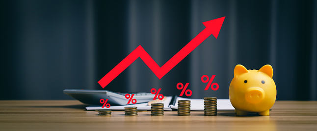 Inflation concept, financial crisis, Pile of coins with red arrows showing percentages on the desk. higher price inflation and more expensive food. calculator, account book, piggy bank