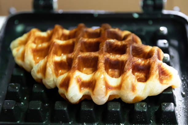 istock Croffle; Croissant+Waffle on cast iron waffle on a stovetop. 1428022733