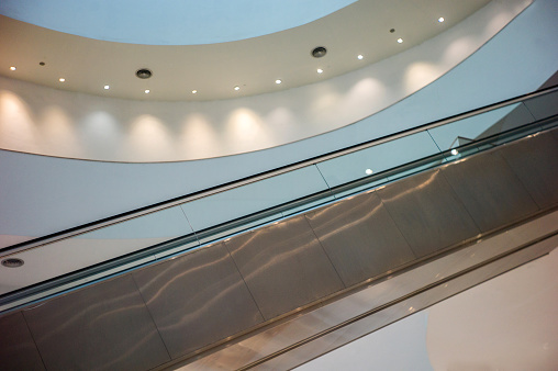 Top view of escalator stairs in shopping mall copy space