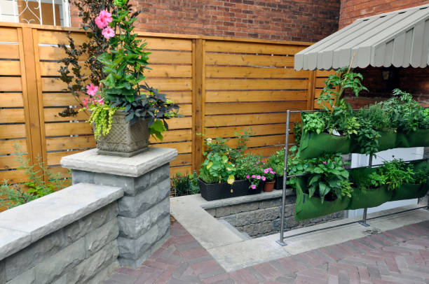 istock Details of a backyard walkout and retaining wall with pillars and coping in a fully landscaped garden. 1428026710
