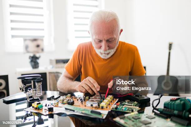Computer Repair Service Hardware Support Electronic Technology Shot Of Technician Fixing Laptop Cooler Stock Photo - Download Image Now